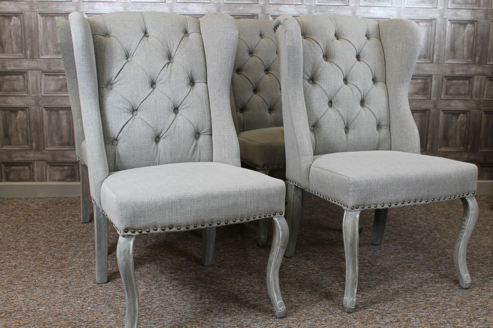 WINGED UPHOLSTERED FRENCH STYLE DINING CHAIRS WITH BUTTON BACK IN STONE